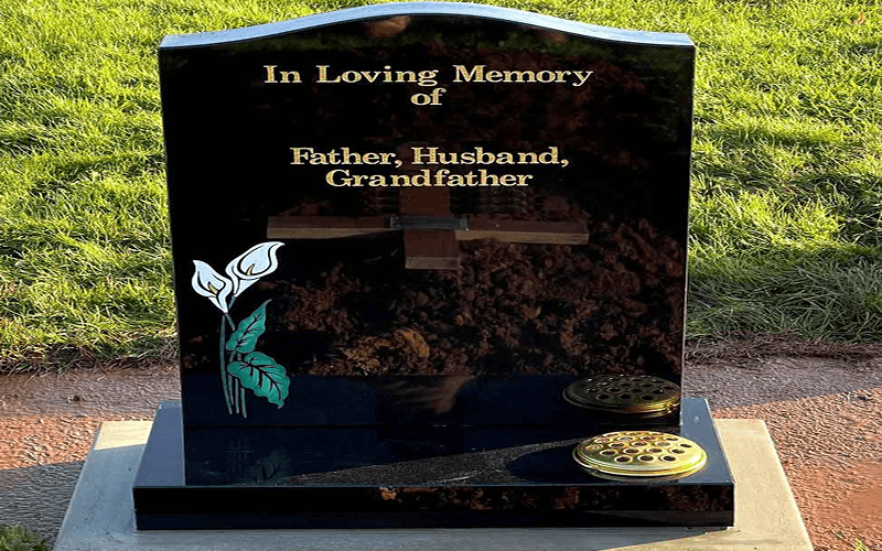 black granite headstone with gold paint lettering